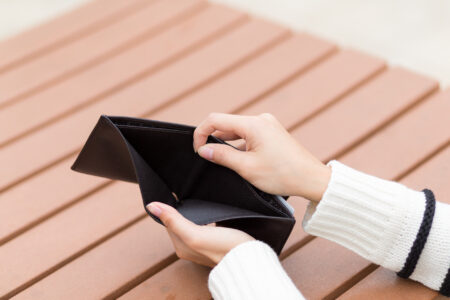 Woman holding an empty wallet